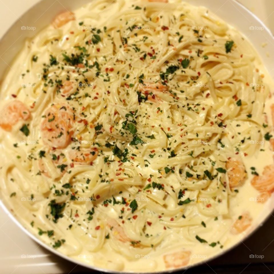 Creamy Tasty Shrimp Alfredo Made from Scratch with Parsley to top it off with some heat from crushed red peppers.