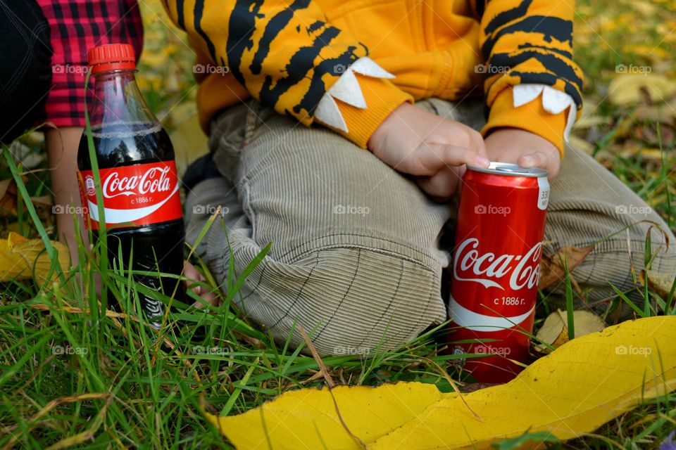 coca cola in hand child drinking coca cola outdoor