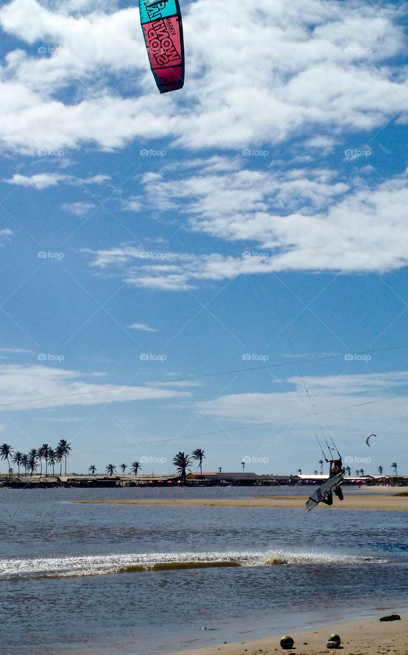 Man practicing kitesurfing in the lagoon of Icapuí