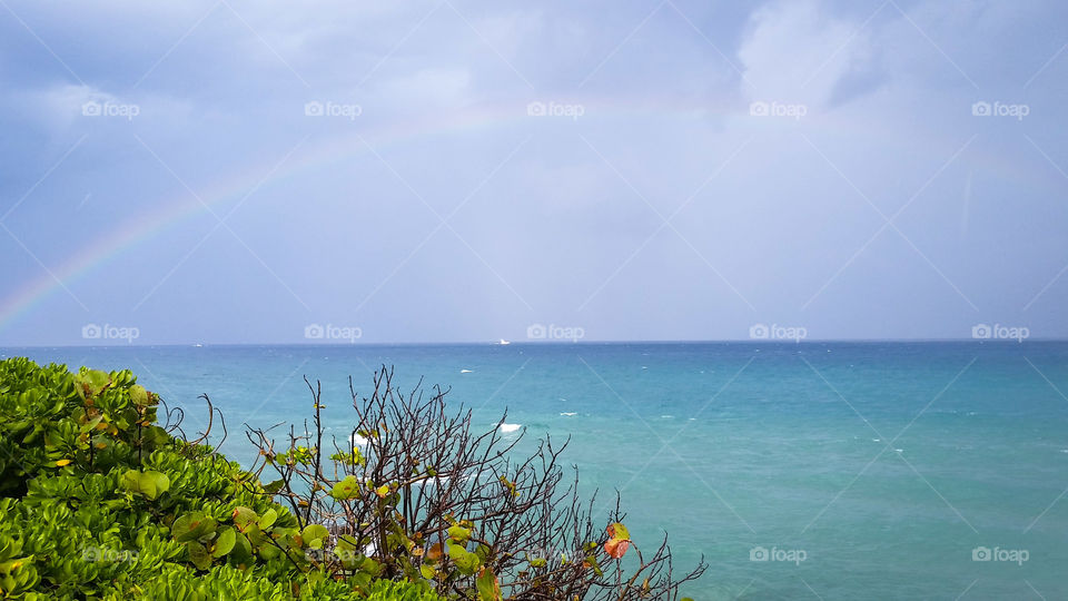 rainbow and turquoise ocean