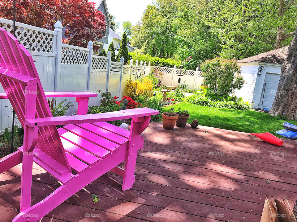 Pink chair in a garden setting 