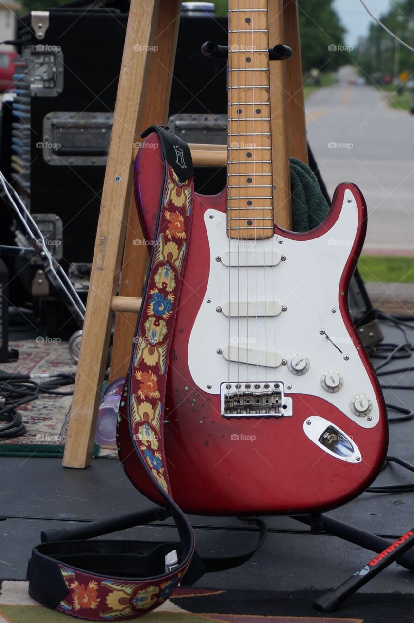 Sweet guitar strap. Street view in background