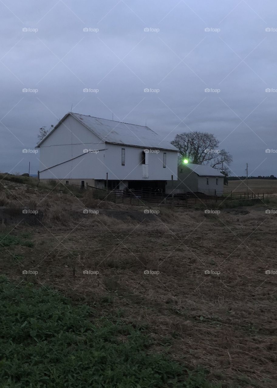 Old barn at evening trees sky 