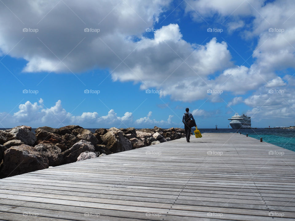 Man on pier with cruise ship