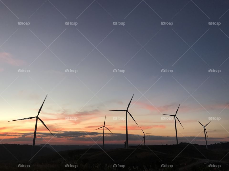 Wind turbine rotate in sunset time to operate electric current