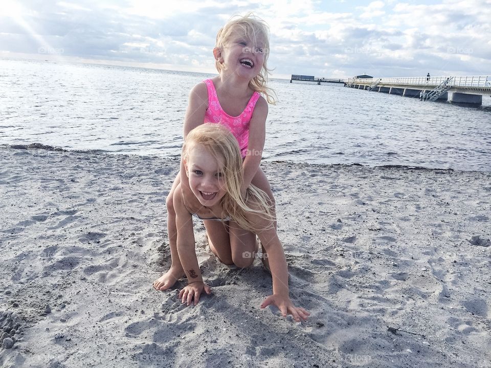 Cute sibling playing on beach