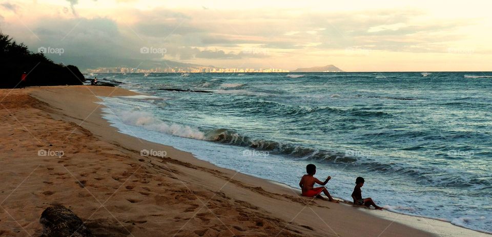 Boys playing on a beach in Hawaii