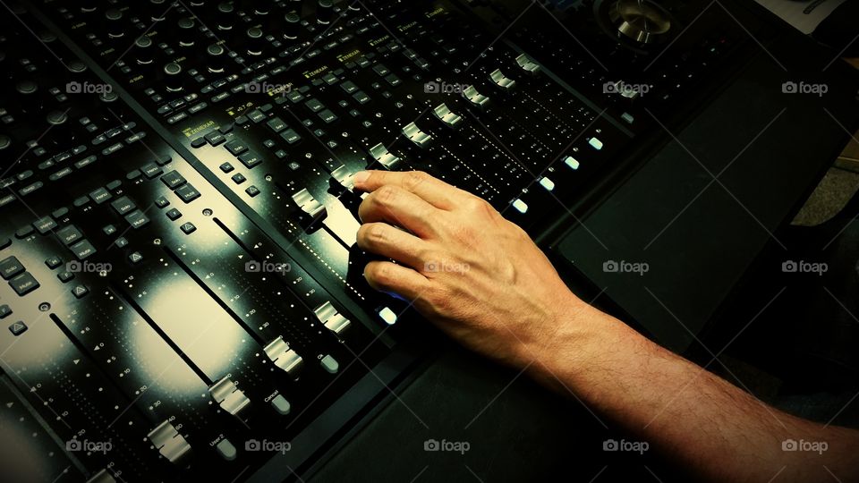 Sound engineer mixing on a mixing desk 