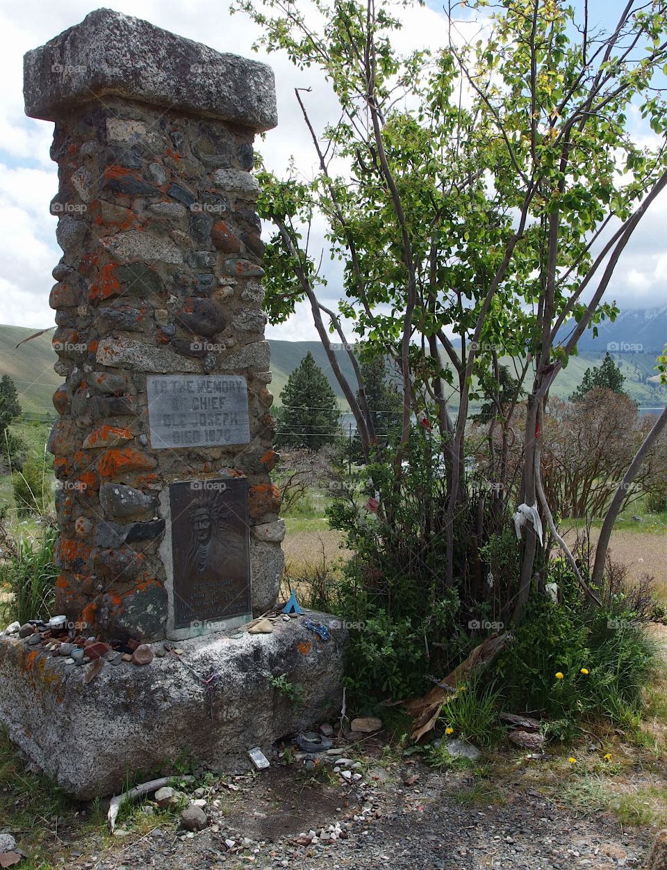 The stone memorial marks the burial site of Chief Joseph in Northeastern Oregon on a spring day. 