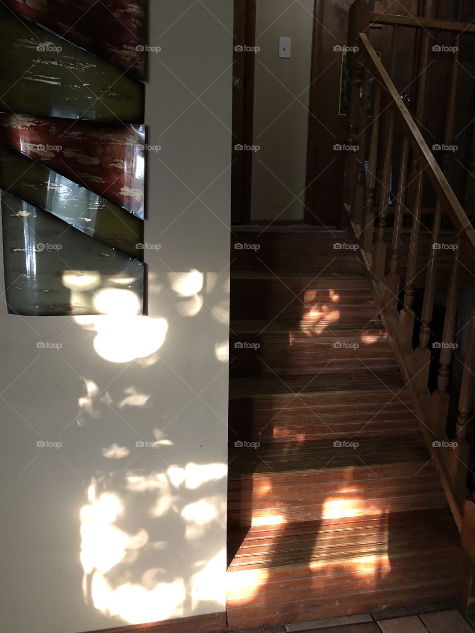 Light shadows from window on wall and stairs