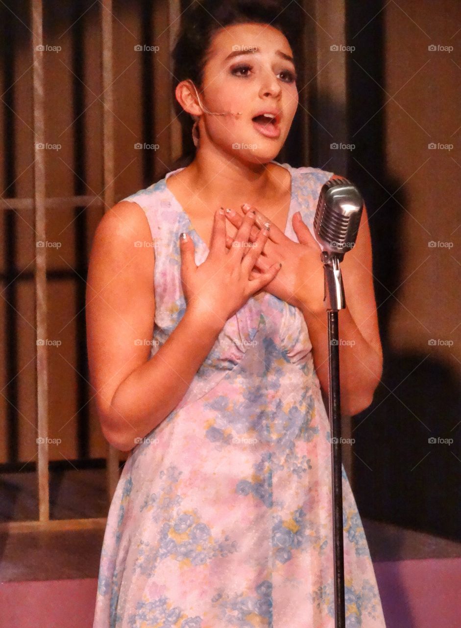 Teenage Girl Singing On Stage