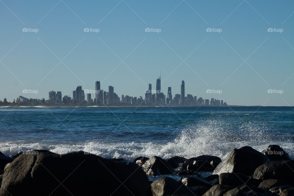 Sea in front of cityscape