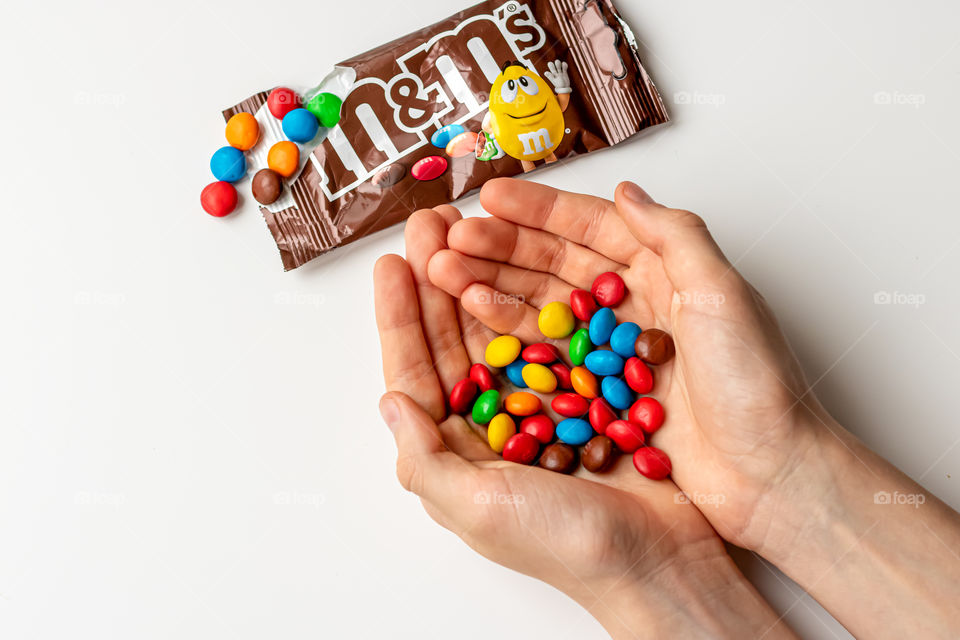 Top view of hands with M&M's.