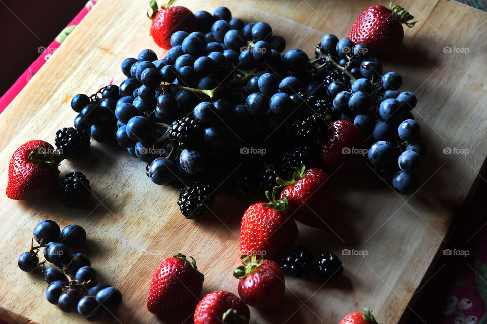 An assorted and colorfully fresh gathering of the incredibly healthy fruits of the berry family.