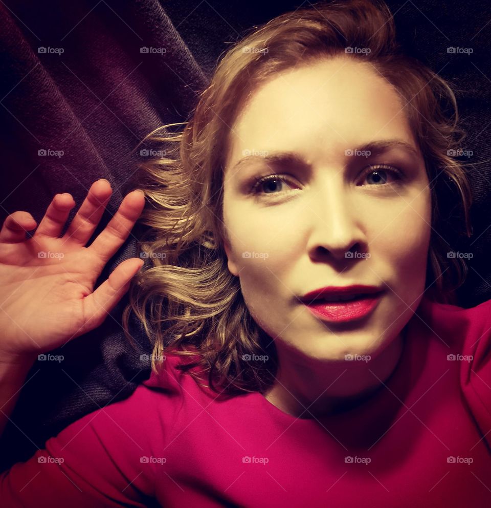 Selfie in a pink top and a hand near my head