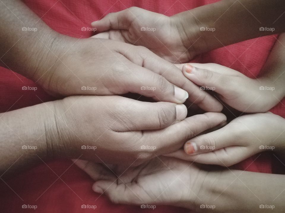 Close-up of mother with child holding hands