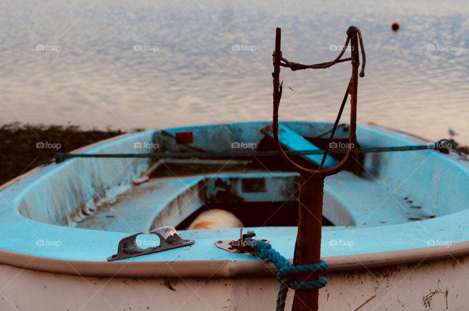 Fishing boat tied to post 