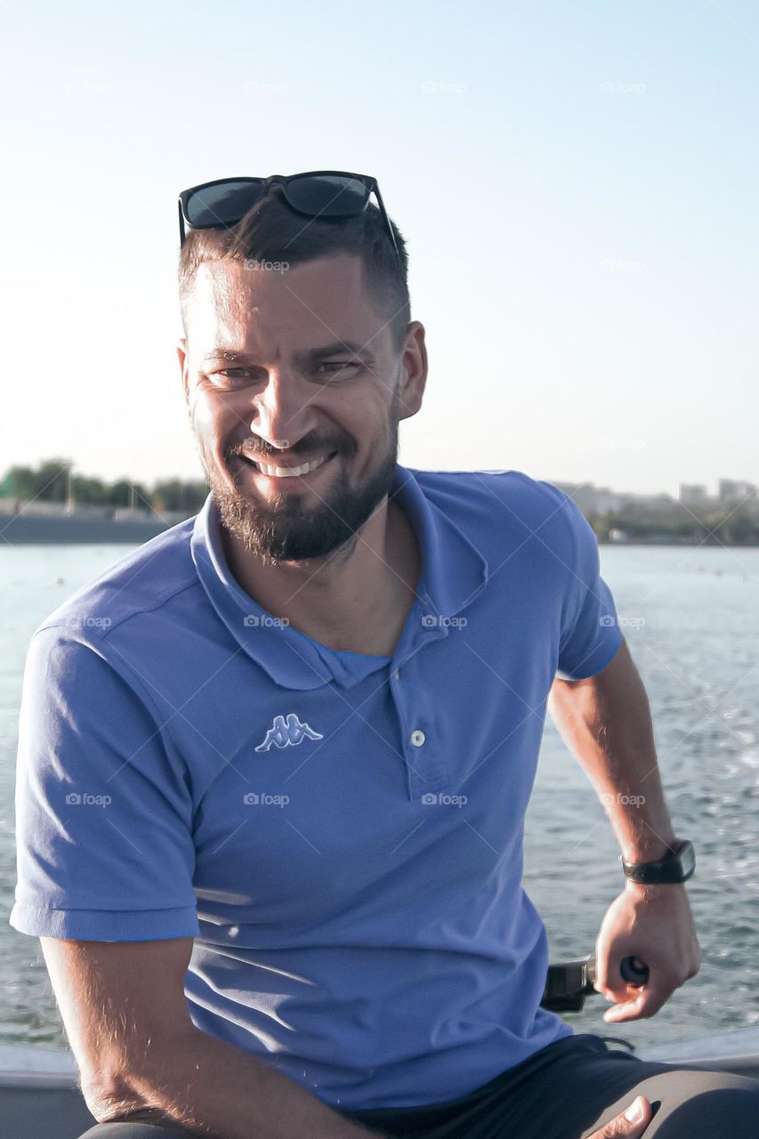 Happy guy rides in a boat