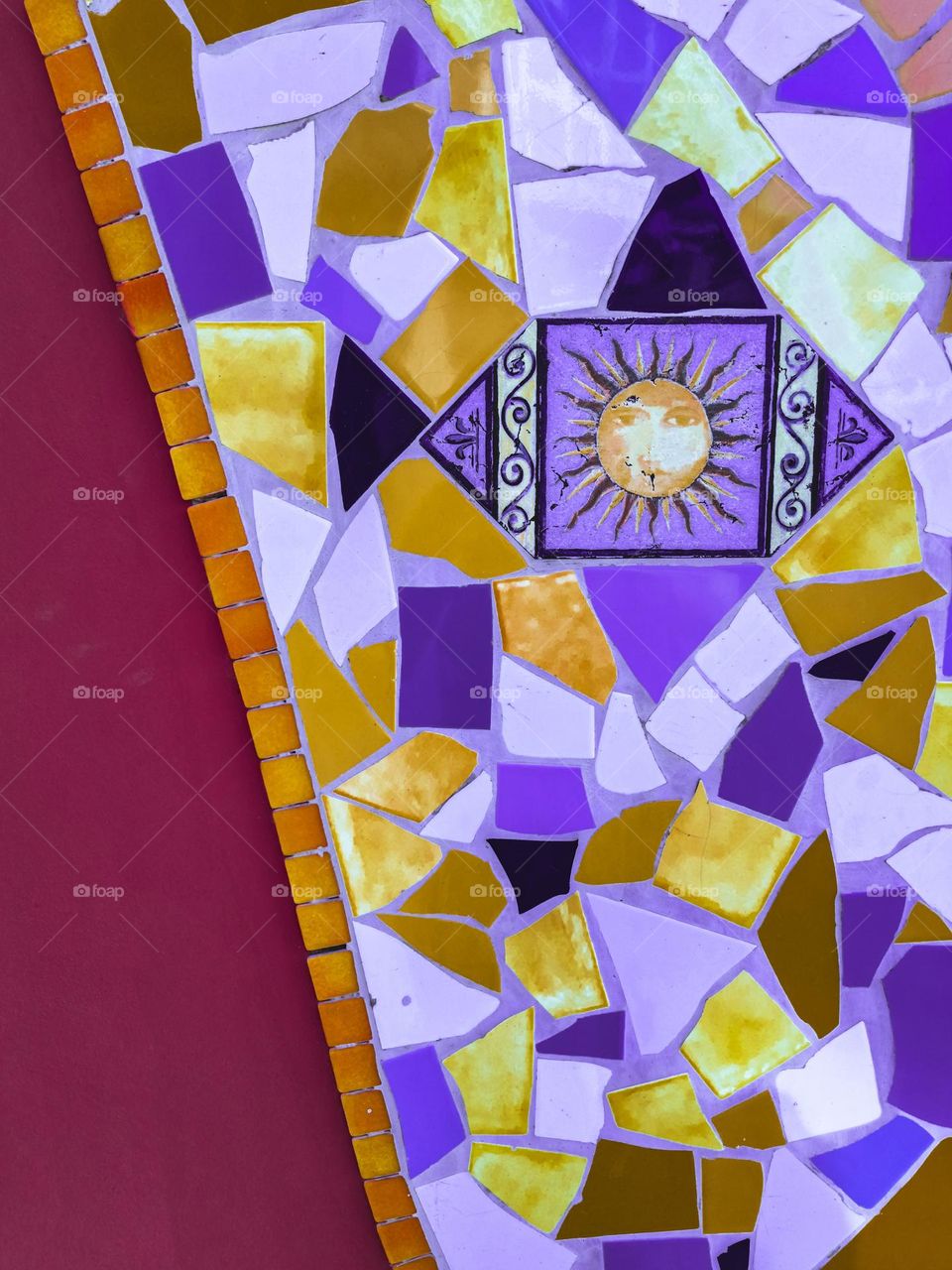 colourful mosaic wall with a sun