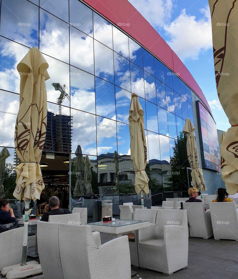Reflection of the cloudy sky on the glass facade