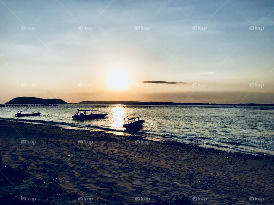 Sunset on the beach with boats 