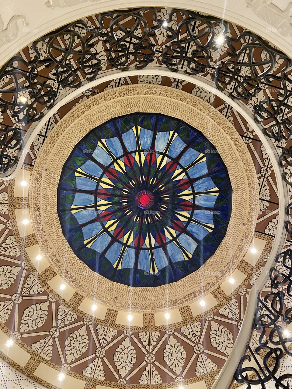 Looking up at the ceiling at the bottom of a staircase