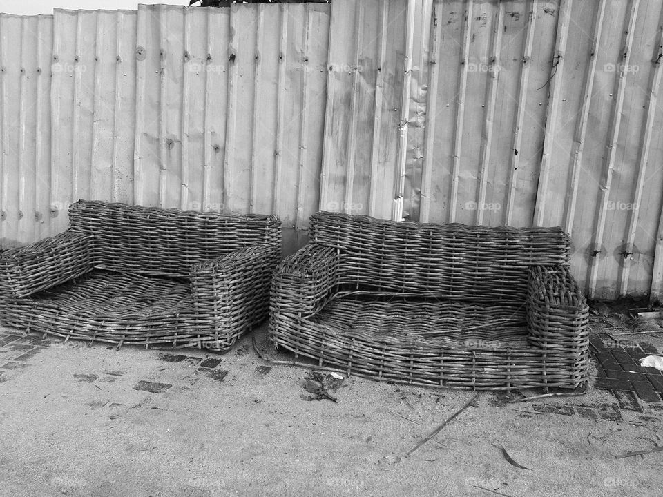 Two wooden old sofas that are suitable ofr the museum