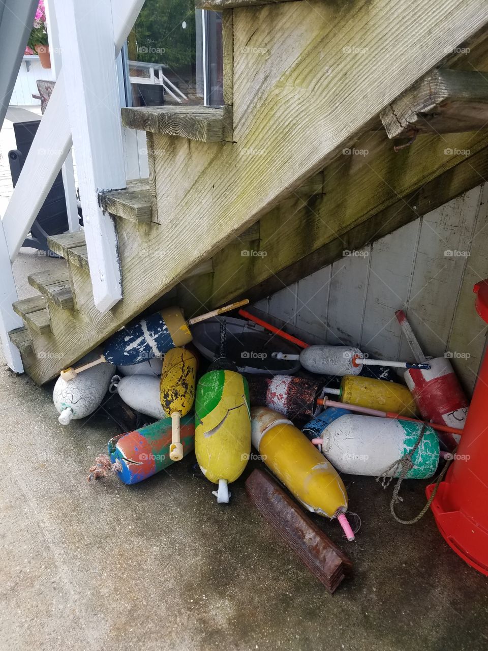 Lobster buoy under stairs Boothbay Harbor Maine