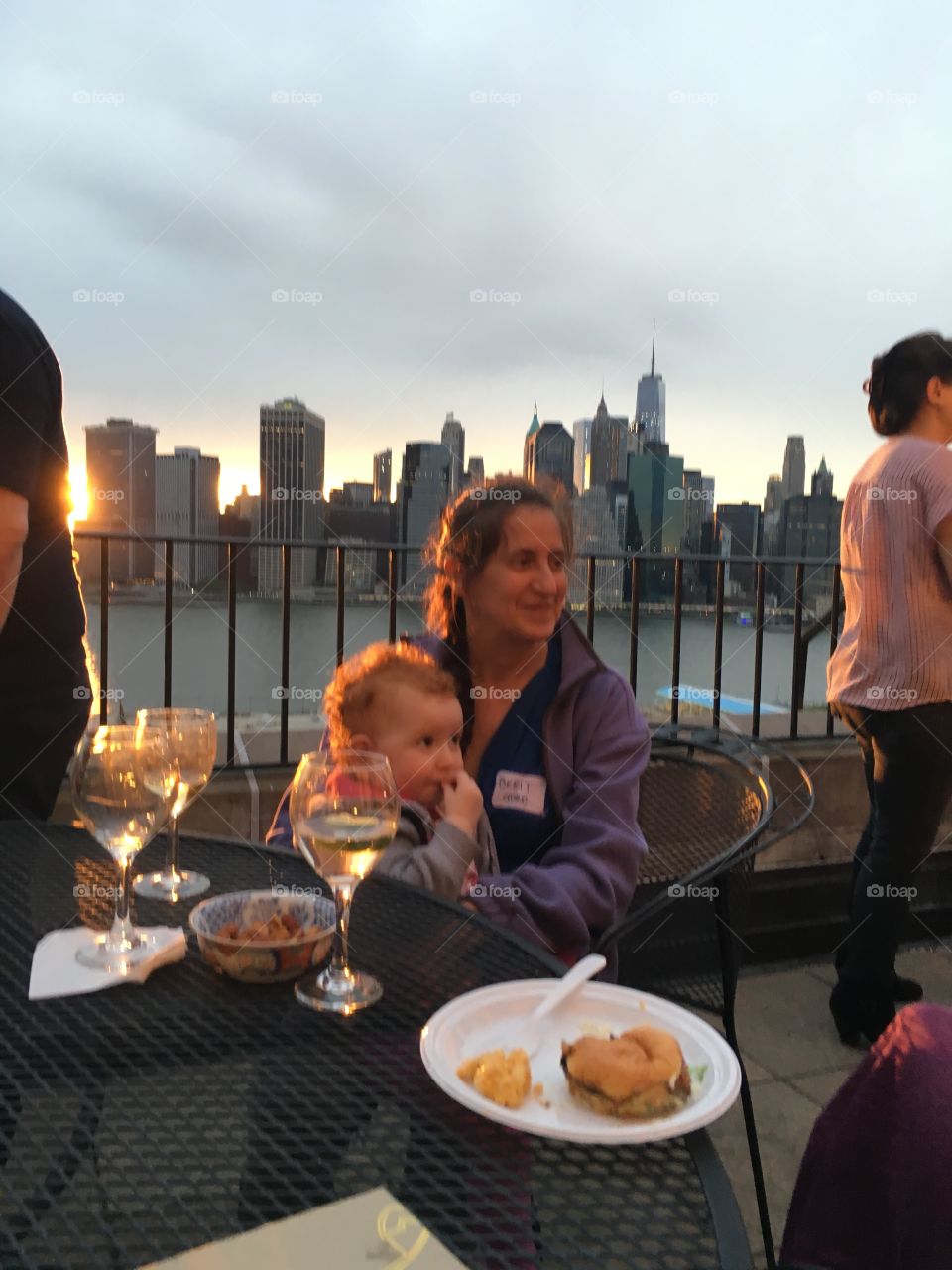 A dinner party at a luxury home on Pierrepoint Place with magnificent views of the Manhattan skyline and arial views of Brooklyn, NY from the balcony. Photo from 2017. Hypnotic Productions