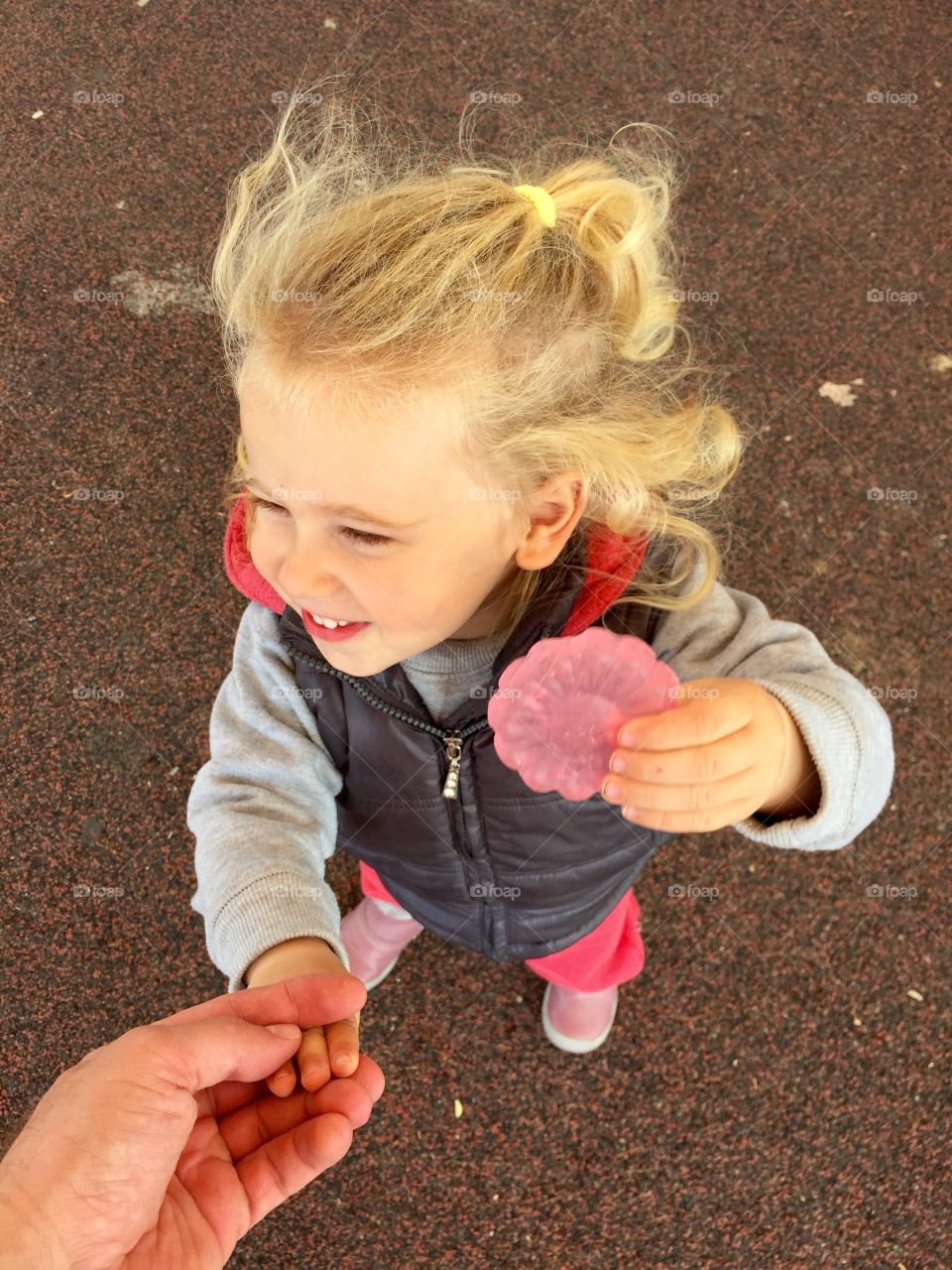 High angle view of cute girl holding candy