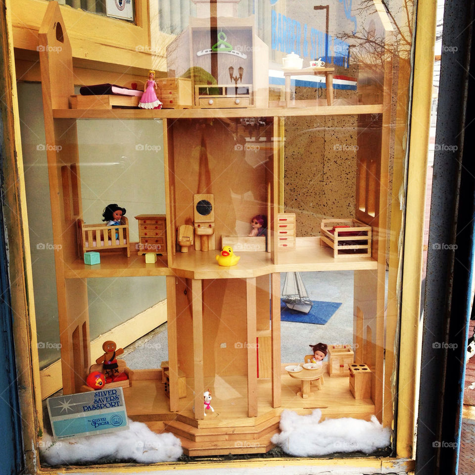 A random wood dollhouse in the window of a barber shop in Camden, New