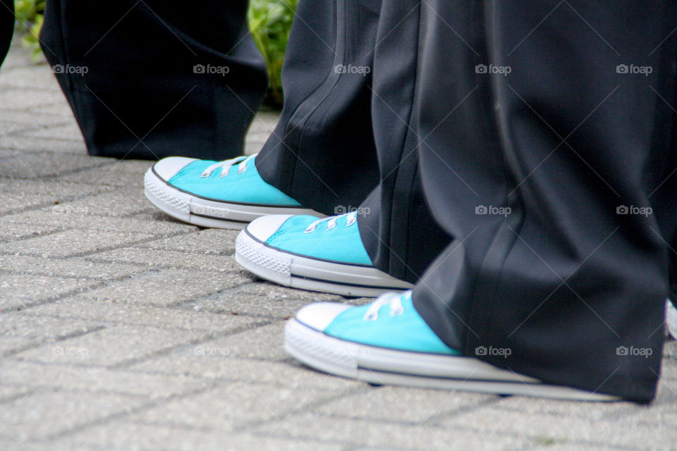 Men's feet wearing matching converse shoes 