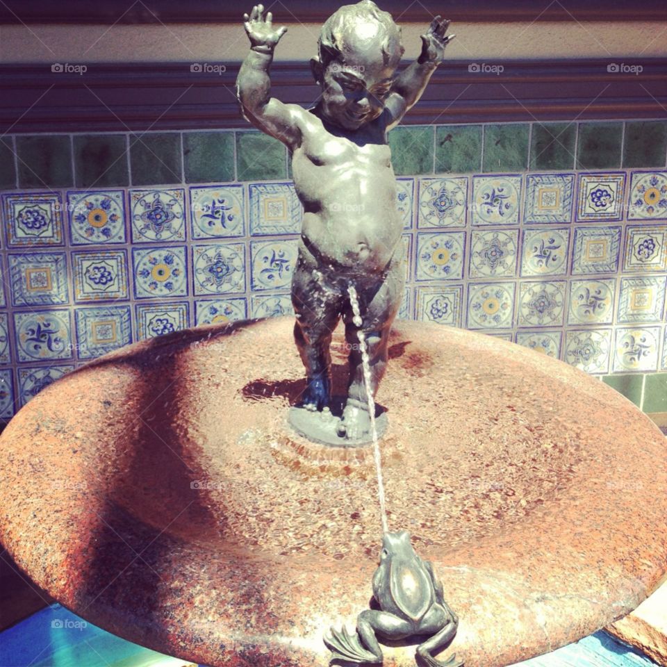 A cheeky fountain of a peeing boy on the plaza
