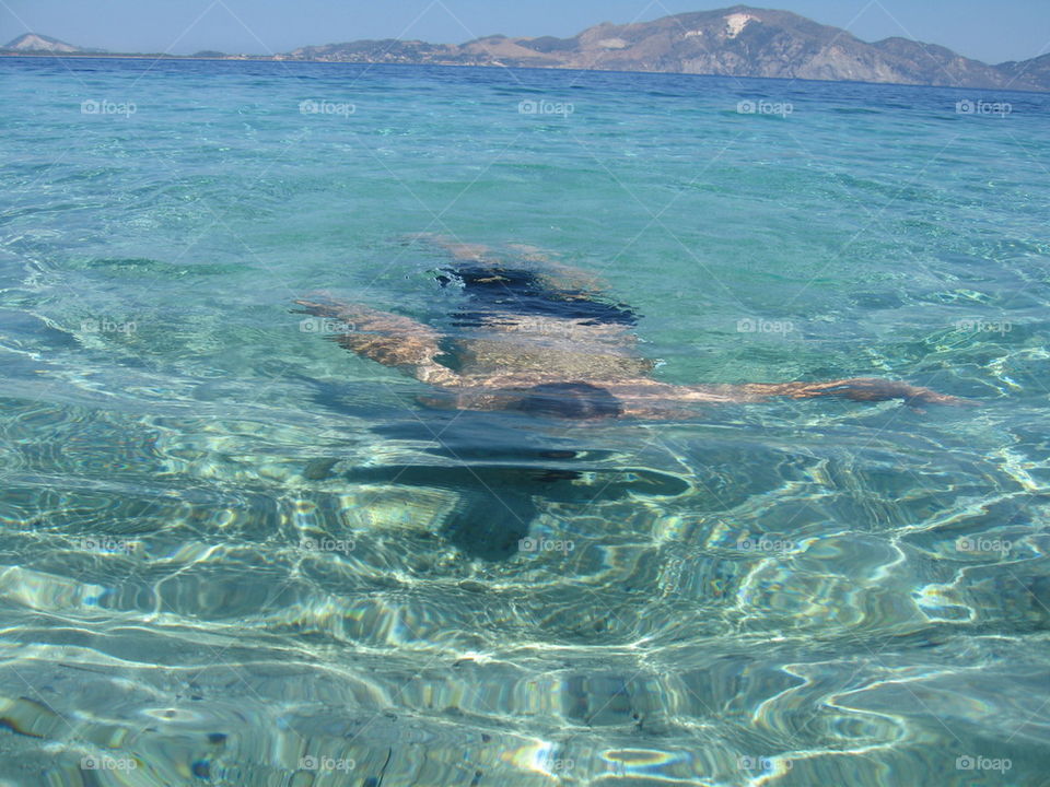 man diving in clear sea