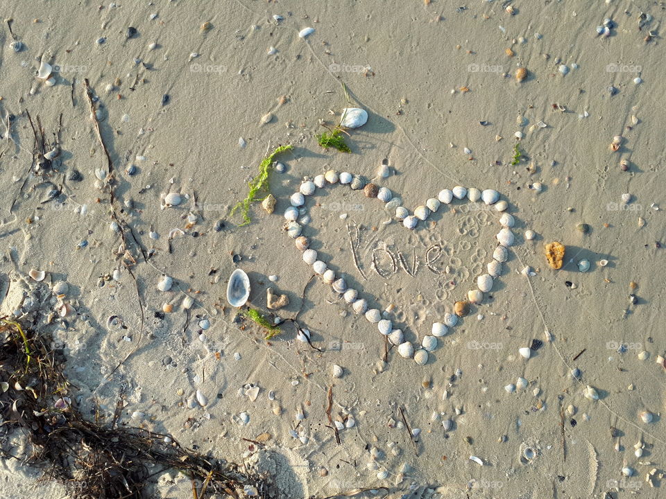 Heart from shells on the sand