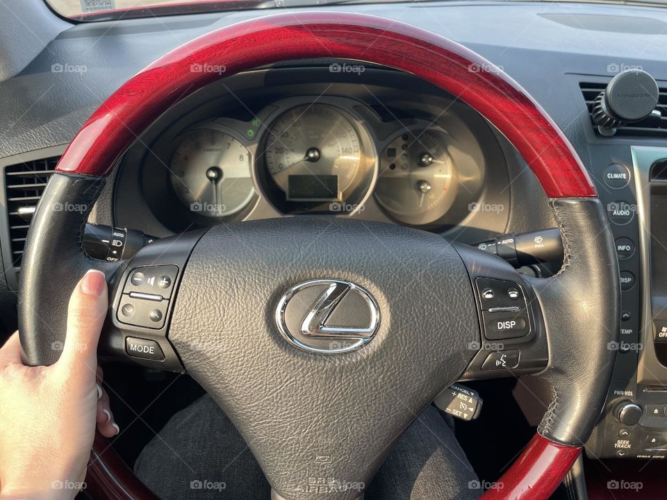 Female’s hand on the Lexus steering wheel