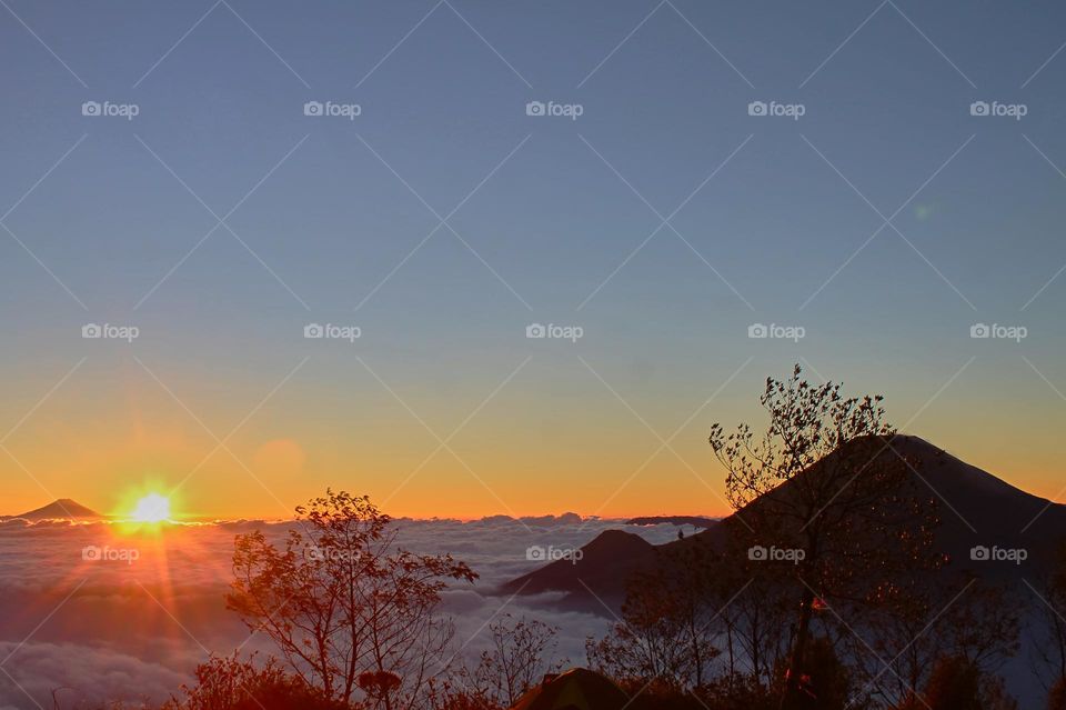 Panoramic view of Sea of clouds on colorful sunset in the mountains.