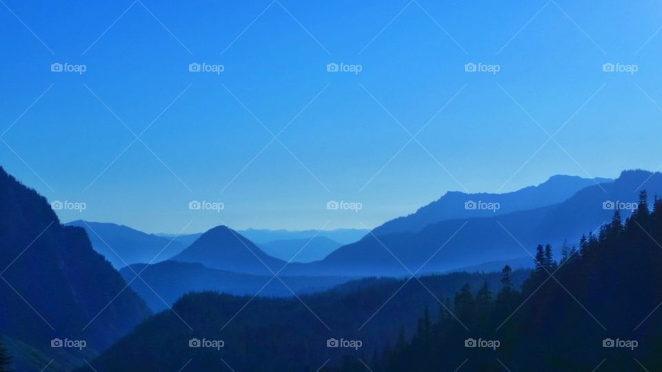 Bold, beautiful and blue sky over mountains, valley, hills, terrains and plateaus during the blue hour.