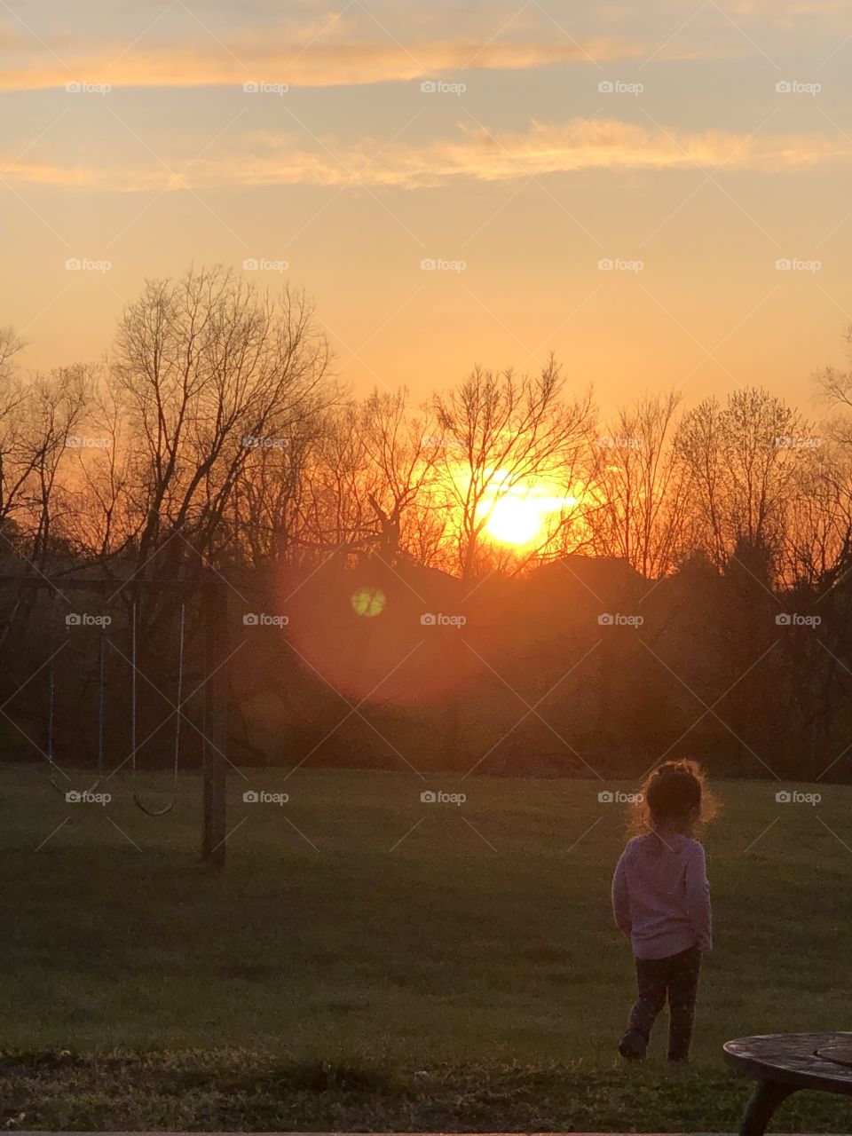 Child playing at Sunset