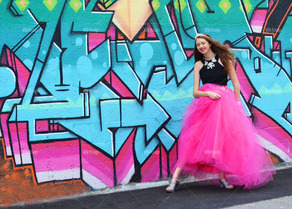 Portrait of a beautiful woman standing in front of wall