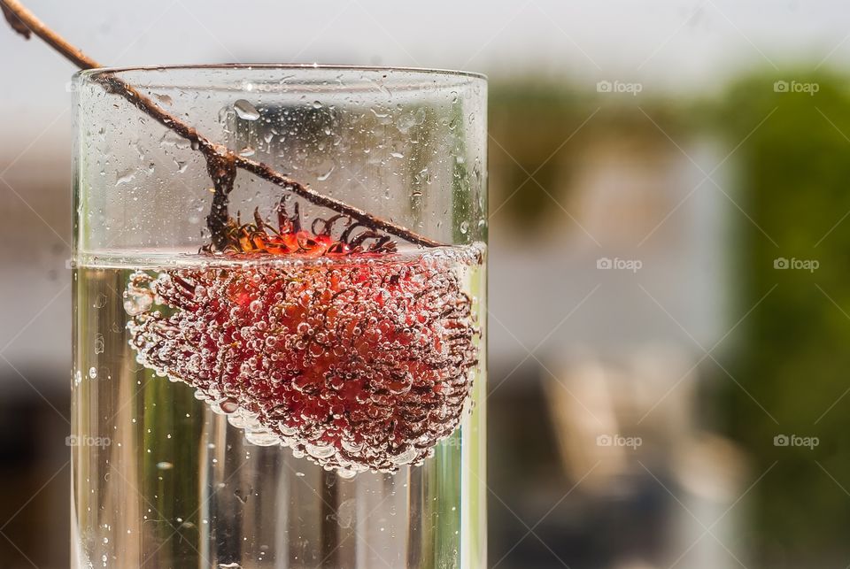 Close-up of rambutan in drinking glass