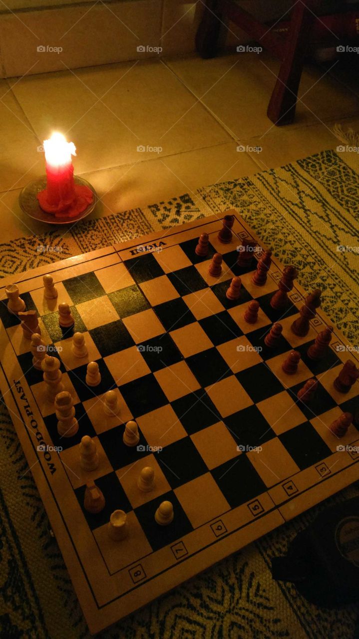 Chess board with candle light