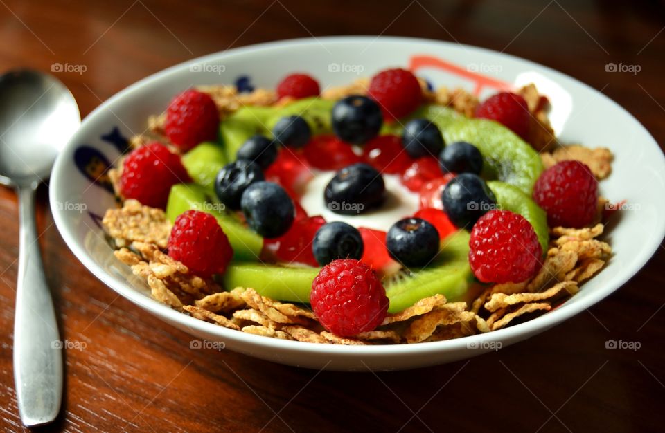 Healthy breakfast of cereal, fruit, berries and greek yoghurt
