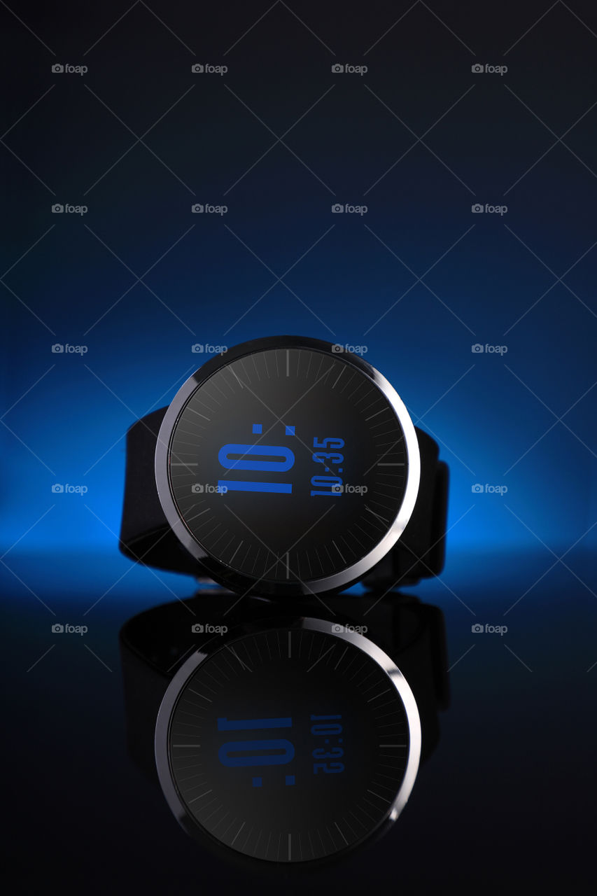 Smart watch or fitness tracker on blue background