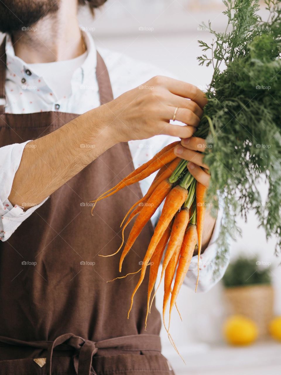 Male holding bunch freshly carrots