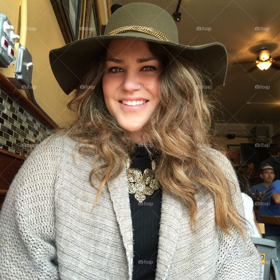 A beautiful woman flashing her big smile during brunch. 