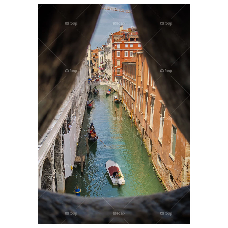 Peeking through a building at one of the many canals in Venice!