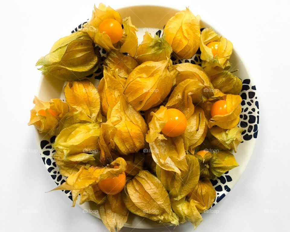 Plate with delicious sweet-sour physalis fruit