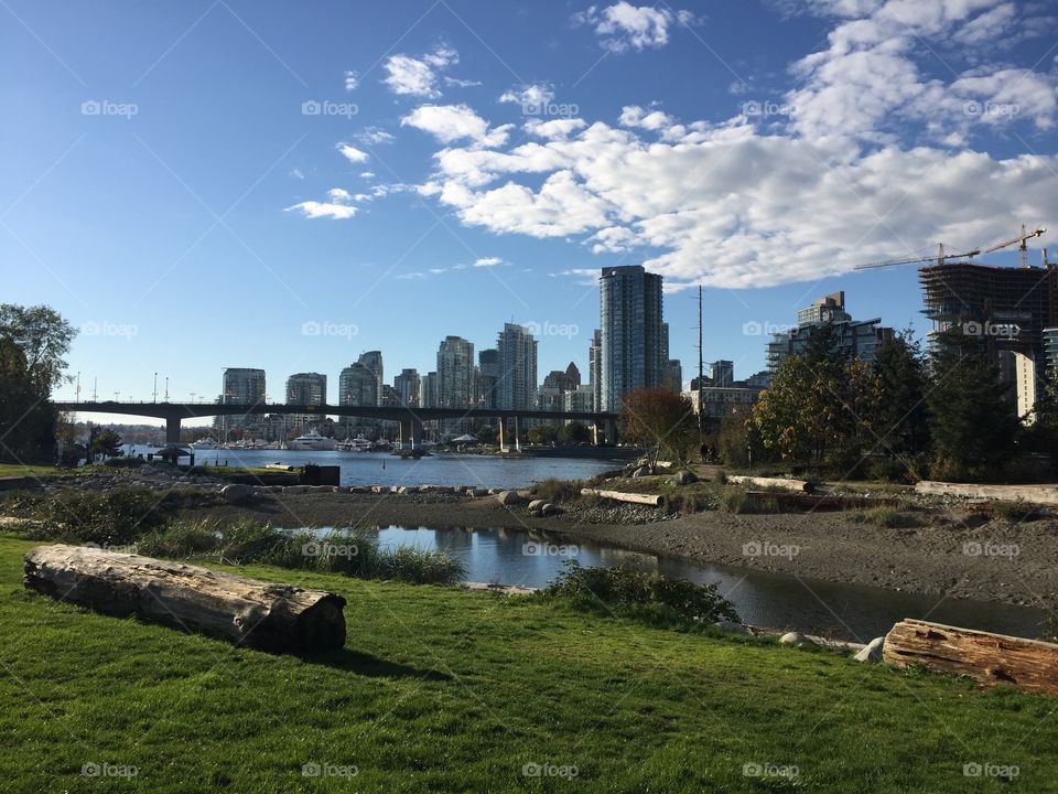 View of downtown Vancouver, British Columbia from the south side of false creek on a clear, sunny autumn day
