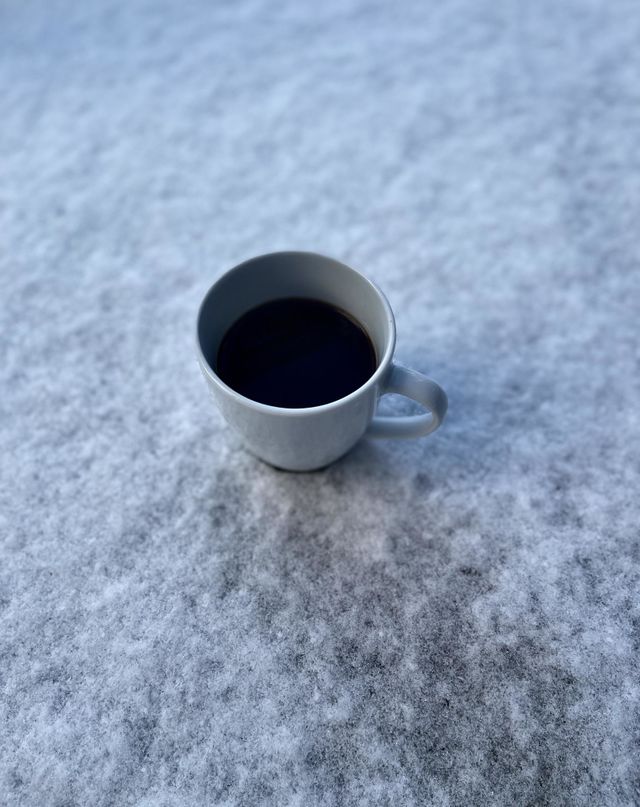 CUP OF COFFEE IN FRESH SNOW